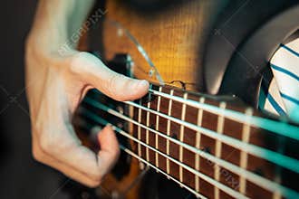 Bassist slapping electric bass guitar