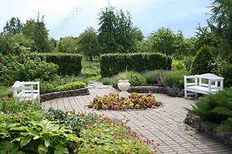 Garden with two white benches