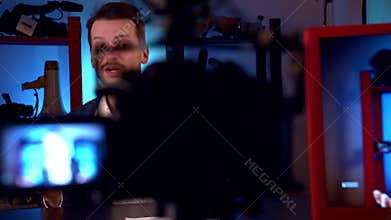 Blogger is broadcasting in video studio with cameras and professional lighting