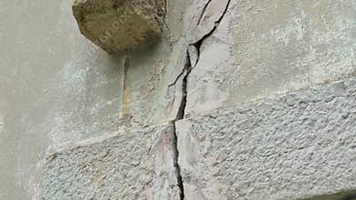 Fracture in a concrete wall. Fissure of cracked building close-up.