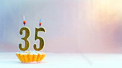 Happy birthday card from candles with the number  35, golden numbers from candles for congratulations on any holiday.