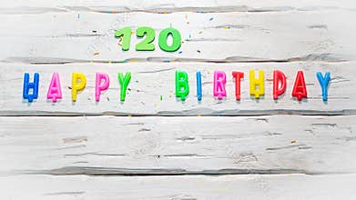 Top view of happy birthday 120 candle numbers copy space on wooden white pastel boards. Beautiful birthday card with number