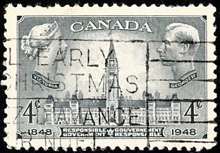Postage stamp reproducing Queen Victoria. Parliament Building, Ottawa, and King George VI.