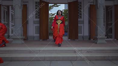 Energetic Group of Dancers in Traditional Red Costumes