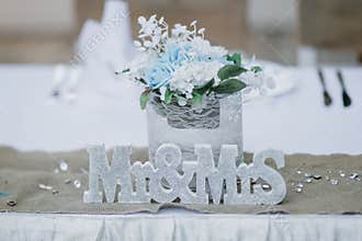 Closeup shot of floral wedding decorations and Mr and Mrs sign