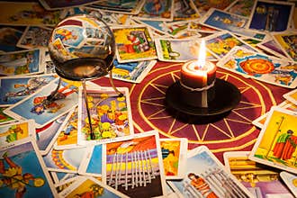 Tarot cards with a candle and crystal ball.