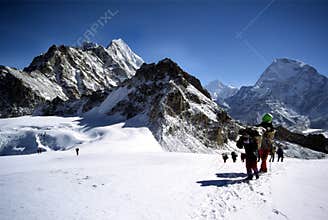 Sherpas and climbers crossing an Himalayam glacier
