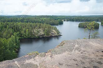 Fog over the lake, rocks and forest in the Repovesi National Park after the rain - view from Katajavuori Hill