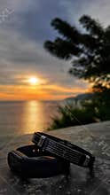 Belt with cross logo in sunset background