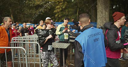 Crew members overseeing at entrance gates in start area. Organization of sports event. Marathon run race, Berlin
