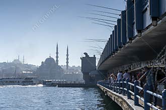 Fisherman fishing at the top of Galata Bridge Galata KÃ¶prÃ¼sÃ¼ and And below it are Restaurants that serve fish meals