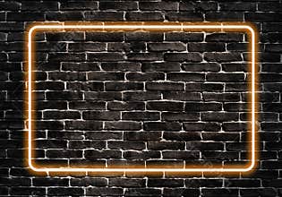 Orange neon glowing frame on a black brick wall design template