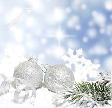 Christmas baubles and silver ribbon on snow