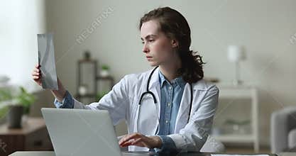 Medical worker analyze x-ray, reviewing patient health state result
