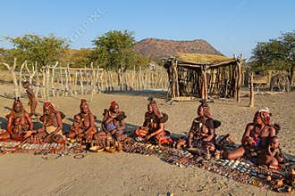A group of Himba women offer their crafts to tourists visiting their village in Opuwo. Namibia.