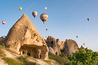 CAPPADOCIA, TURKEY - APRIL 18, 2018: Colorful hot air balloons flying over rock landscape at Cappadocia Turkey
