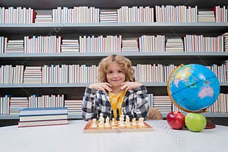 Child play chess. Chess for intelligent kid. Child genius, smart pupil playing logic board game. Clever school boy