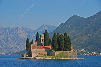 Island of Saint George Sveti Dorde, an islet off the coast of Perast in the Bay of Kotor, Montenegro mountainous background