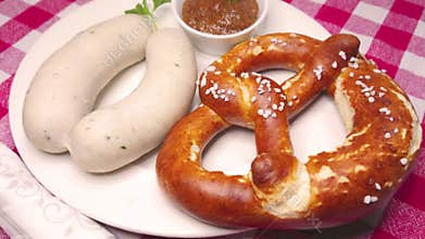 Two munich white sausages, pretzel and sweet bavarian mustard, rotating
