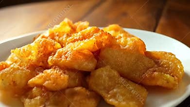 Close Up of Golden Fried Mexican Bu?uelos also known as New Mexico Sopaipillas on Wooden Table in Warm Light