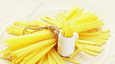 Pasta bunch still life rotating on a wooden plate