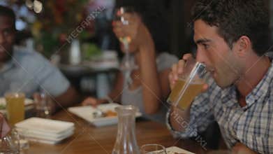 Group Of Friends Enjoying Meal In Restaurant