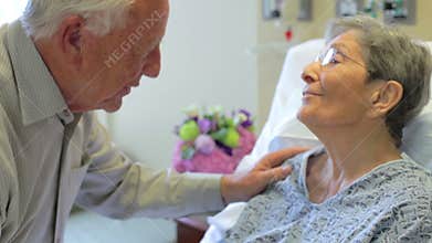 Senior Man Visiting Wife In Hospital Room