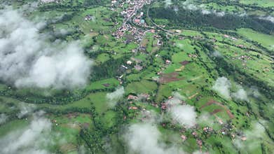 Aerial view of lush countryside with village, forest, and mountains, Infiesto, Asturia, Spain.