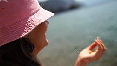 Beach Girl Woman: Young person looks to the sea during daytime in a summer holiday scene.