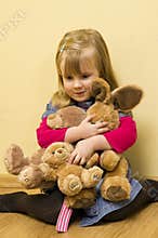 Little girl holding toys