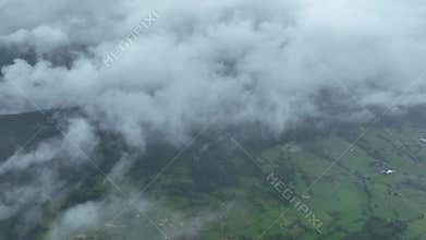 Aerial view of lush countryside with village, forest, and mountains, Infiesto, Asturia, Spain.