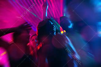 Party people dancing in disco or night club