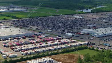 Aerial view of car factory parking lot with many brand new cars for sale. Development of American automotive industry concept.