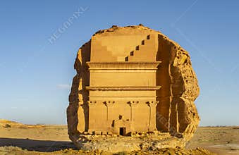 The front view of the largest rock tomb Qa?r al-Far?d at Hegra in a sunny day