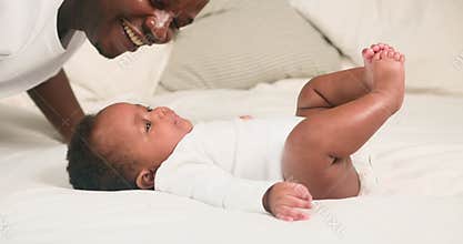 Loving Father and Adorable Baby Share a Tender Moment on the Bed: A Celebration of Family, Love, and Connection