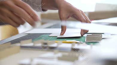 Close Up Of Architect Cutting Out Component For Model