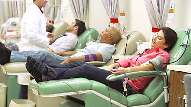 Volunteers Making Blood Donation In Hospital
