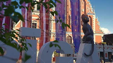 House of the Blackheads and Riga Sign Transitioning Day to Night