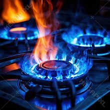 Blue gas stove burner with visible flames in kitchen