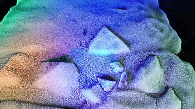 Vibrant mineral crystal formations display rainbow colors, sharp edges. Light refracts through this beautiful natural