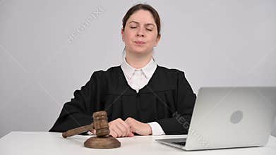 Female judge delivers verdict and bangs gavel.