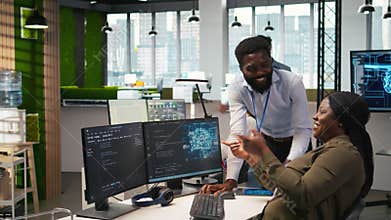 Cheerful programmers in office enjoying conversation while automating with AI