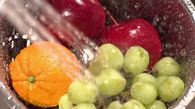 Slow motion shot of fruit washed with spraying water