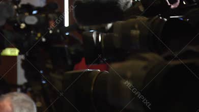 Reporters and cameras waiting for a press conference to begin.