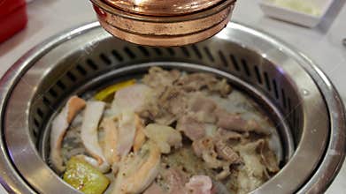 Grilling meal. Korean-style barbecue, where diners grill thinly sliced meat