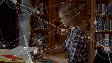 Teenage girl typing laptop with textbook in study area as network nodes growing while woman walking