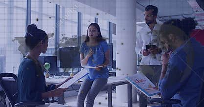 Woman holding clipboard outlining business agenda while team reviewing notes and charts on tablet