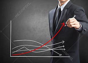 Business man drawing growth chart