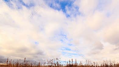 Clouds over dry grass. From top to bottom. Time La