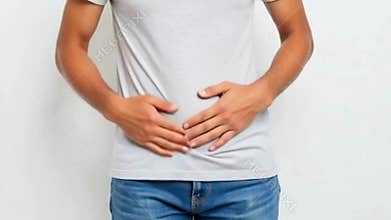 Person Gently Touching Stomach Showing Discomfort Against Plain Light Background